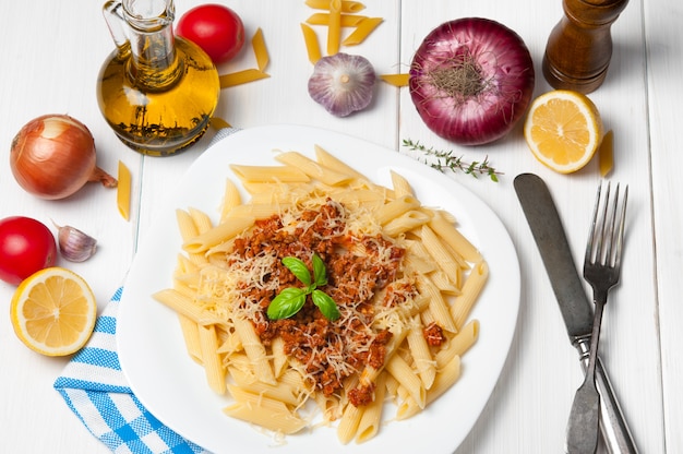 Spaghetti pasta bolognese with ingredients on white wooden. 