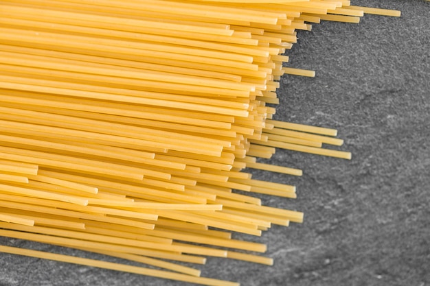 Spaghetti pasta isolated on dark from above