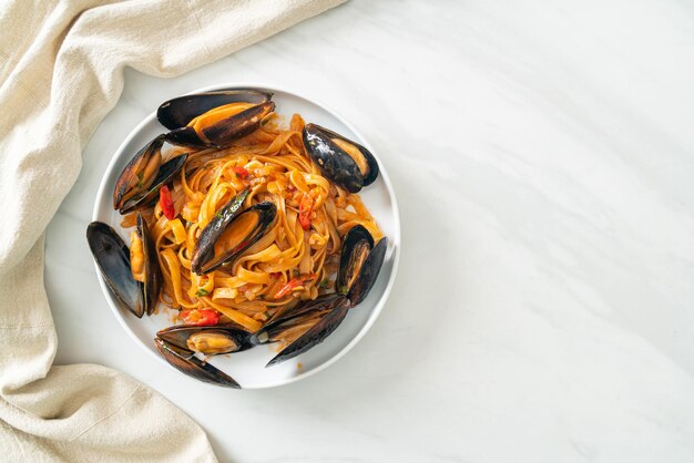 Spaghetti pasta with mussels or clams and tomato sauce - Italian food style