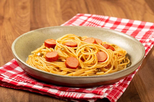 spaghetti pasta with sliced sausages and tomato sauce