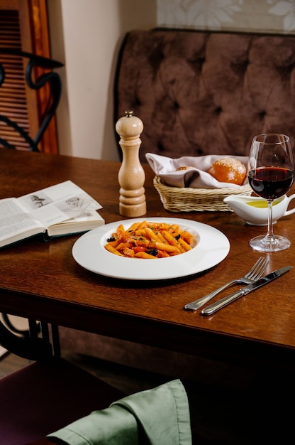 Spaghetti pasta with tomatoes and parsley on wooden table