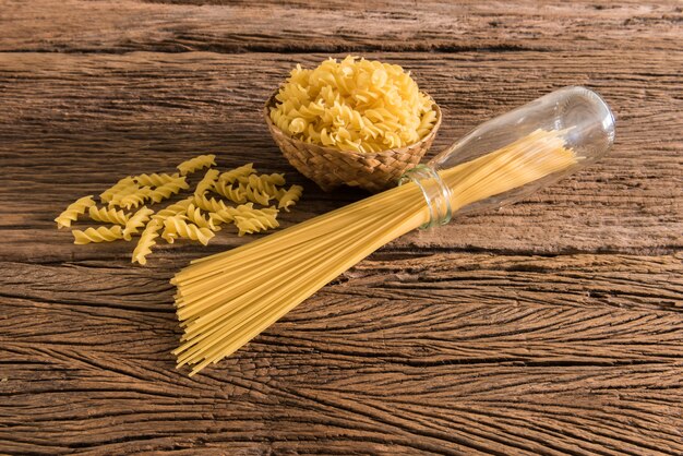 spaghetti and pasta on a wooden table. Photo retro style