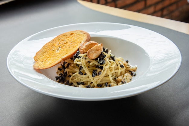 Spaghetti  with Baguette on white plate