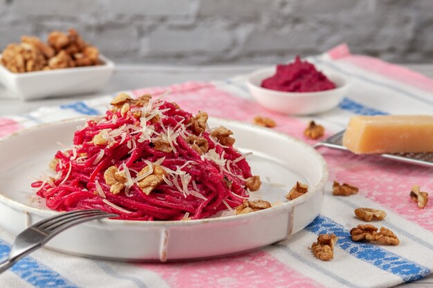 Spaghetti with beetroot sauce walnuts and parmesan