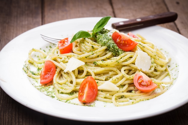 Spaghetti with green pesto, parmesan and cherry tomatoes