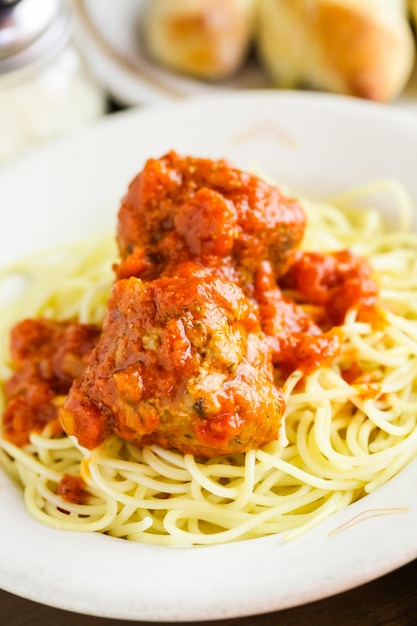 Spaghetti with meatballs on the plate in Italian restaurant.