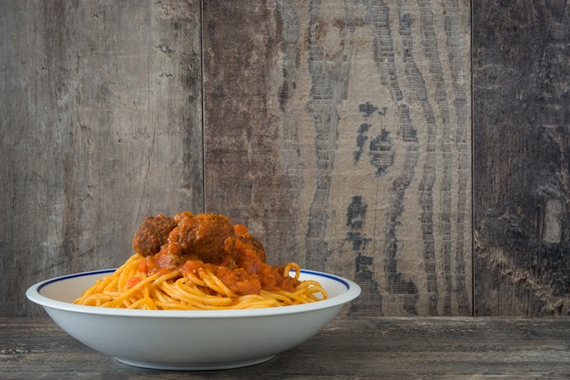 Spaghetti with meatballs on wooden table copy space