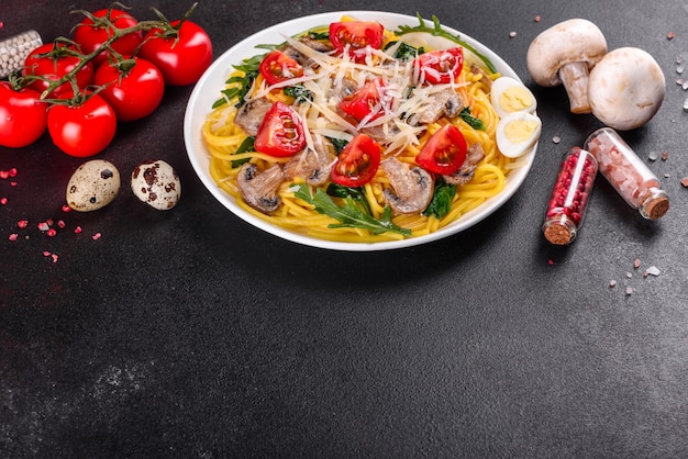 Spaghetti with mushrooms, cheese, spinach, rukkola and cherry tomatoes. Italian dish, Mediterranean culture