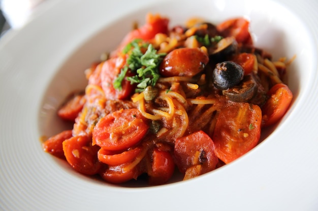 Spaghetti witn tomato and olive , Italian food