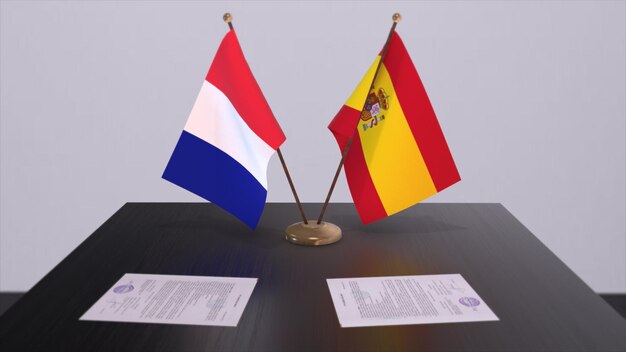外交会議室のテーブルに置かれたスペインとフランスの国旗 政治協定合意