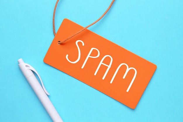 SPAM word in paper card on blue background Business concept