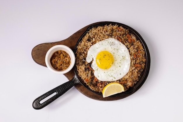 Spambalaya fried rice with sunny egg in a dish top view on grey\
background singapore food