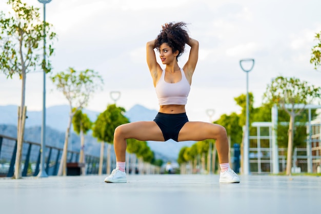 Spanish brazil relaxing her leg and hand muscles in outdoor sport area