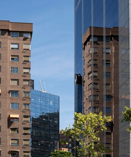 Spanish building architecture in reflected in the windows of a modern building in Madrid city centre