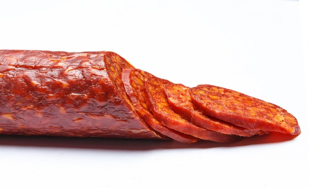 Spanish chorizo sausage on white surface