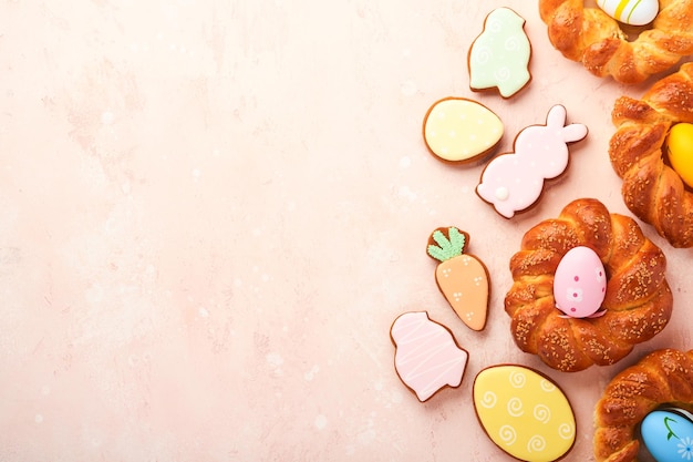 Spanish Easter cake Traditional mona de pascua typical in Spain with boiled eggs eaten inside on pink rustic table background Typical food of the Spanish pastry Mona de Pascua Top view Mock up