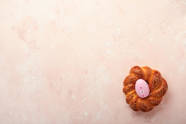 스페인 부활절 케이크 전통적인 모나 데 파스쿠아(mona de pascua)는 삶은 계란을 분홍색 소박한 테이블 배경에 내부에서 먹는 스페인 페이스트리의 전형적인 음식 모나 데 파스쿠아 탑 뷰 모의 업