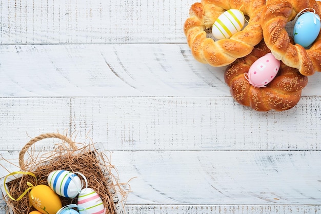 Spanish Easter cake Traditional mona de pascua typical in Spain with boiled eggs eaten inside on white rustic wooden table Copy space Top view Mock up