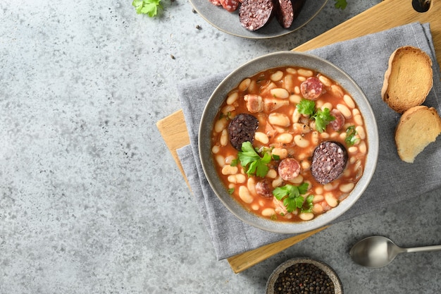 Spanish fabada on gray table copy space