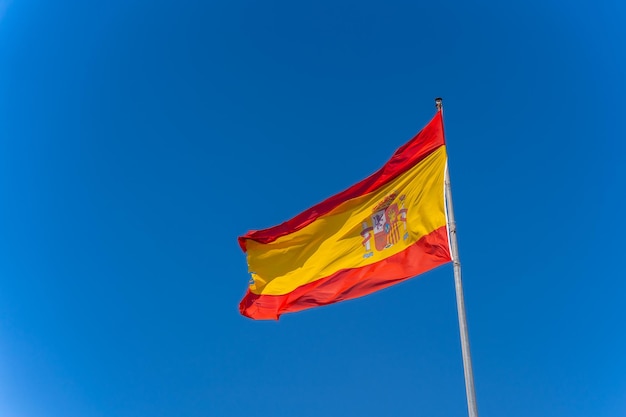 Spanish flag symbol of patriotism held by the wind