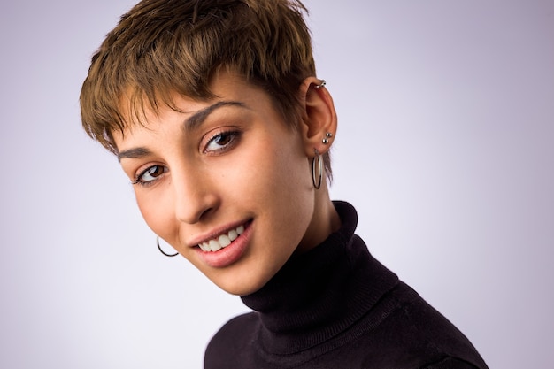 Spanish hispanic young woman headshot insolated in a white background. Smile face from a pretty model with short hair.