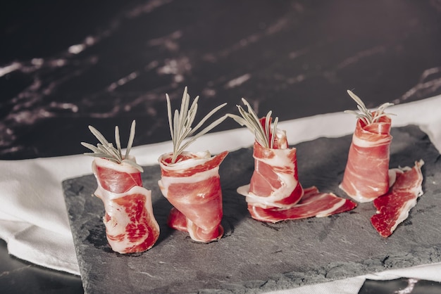 Spanish jamon serrano against a stone background