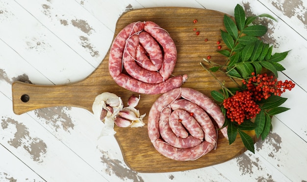 Spanish longaniza, beef sausages  homemade with pink pepper on the cutting board