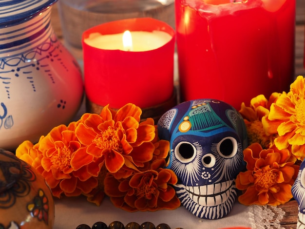 Spanish Mexican traditional autumn festival day of the dead typical Mexican skull with flowers painted on wood background decorations and marigold flowers