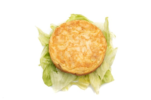 Spanish omelette on top of some lettuce leaves isolated on white background In mini version