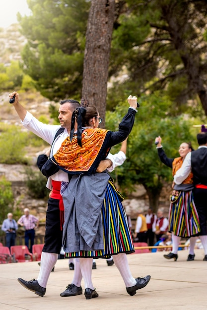 Spanish people wearing traditional clothes dancing