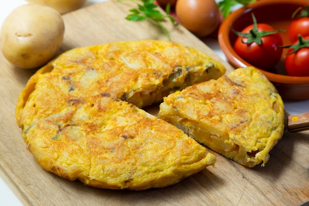spanish potato omelette. traditional tapa recipe with egg, potato, onion.