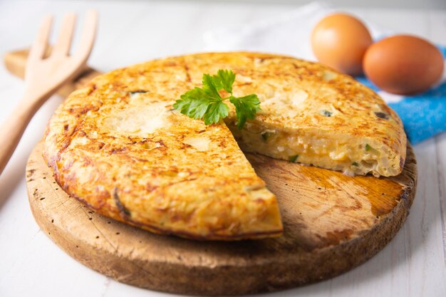 spanish potato omelette with zucchini and young garlic. traditional tapa recipe with egg and potato.