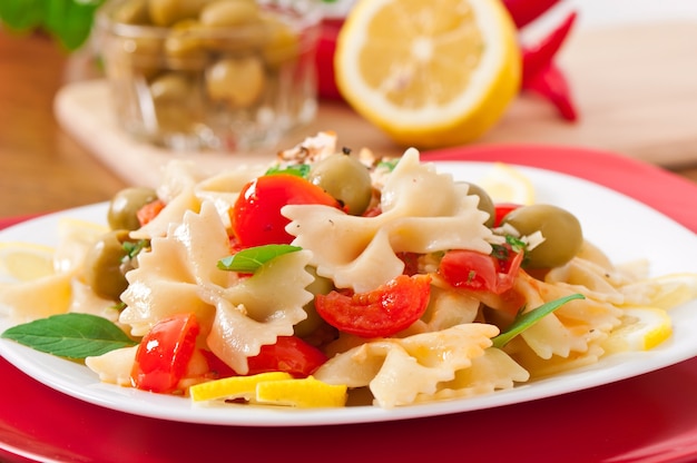 Spanish salad with pasta bows, tomatoes and chicken