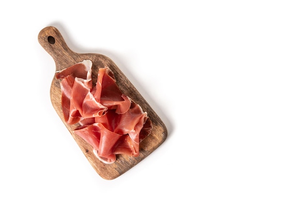 Spanish serrano ham on cutting board isolated on white background Top view Copy space