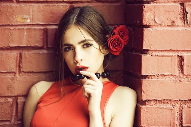 Spanish woman with fashionable makeup and rose flower in hair