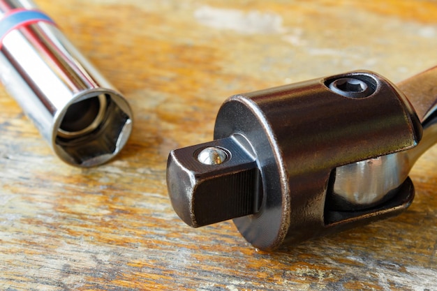 Spanner head and power wrench on a wooden table in the workshop