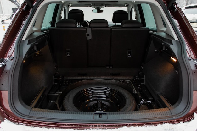 Spare wheel in the trunk of a modern car Jack lifting and a spare tire in rear of car