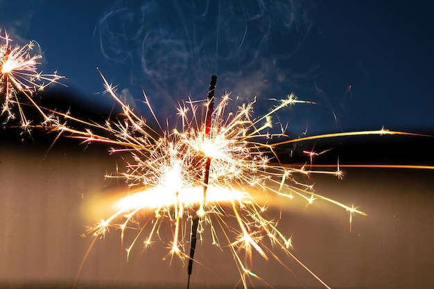 A sparkler is lit up with the word fire on it