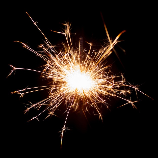 Sparklers on black isolated background Sparks from a burning sparkler To insert an image in a blend mode