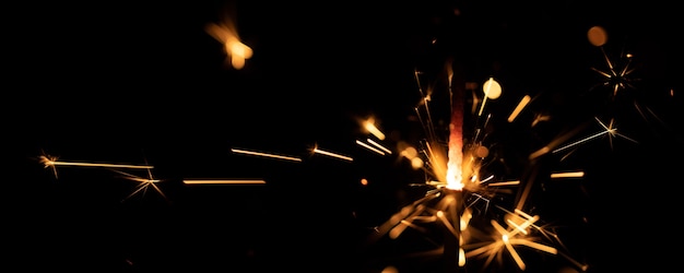 Sparklers flame, on black wall, selective focus.