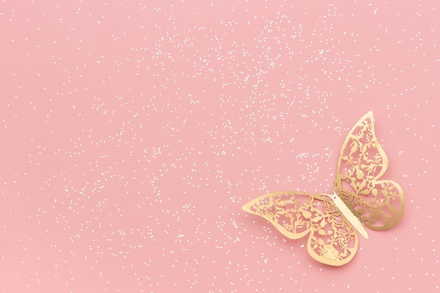 Sparkles glitter and gold tracery butterfly on pink pastel trendy background. 