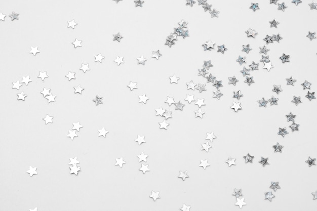 sparkles silver stars on white background with text place image