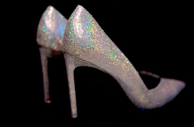 Sparkling elegant highheeled shoes on black background