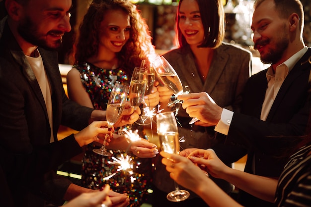 Sparkling sparklers in the hands. Playing firework to celebrate winter holidays. Magic New Year.