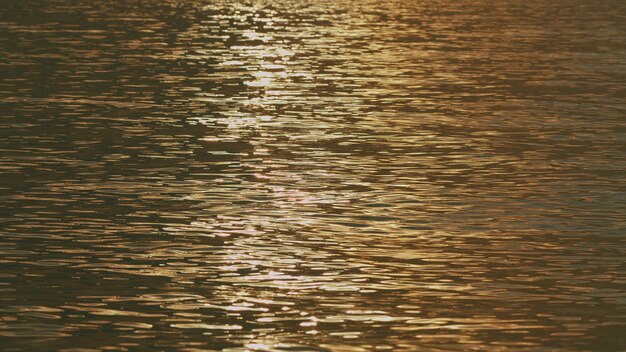 Sparkling sunlight over calm water abstract nautical summer ocean sunset nature background