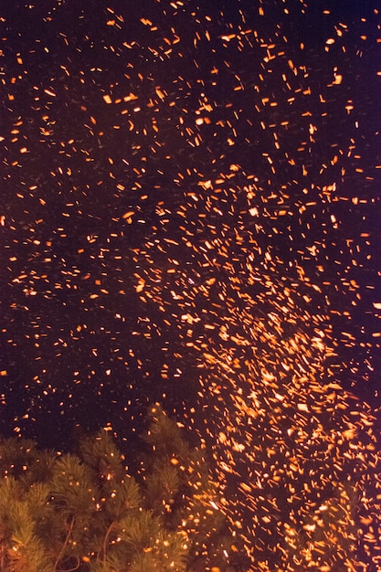 Sparks at night from burning badnjak. Orthodox Christianity custom during Christmas eve