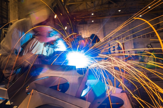 sparks while welder uses torch to welding