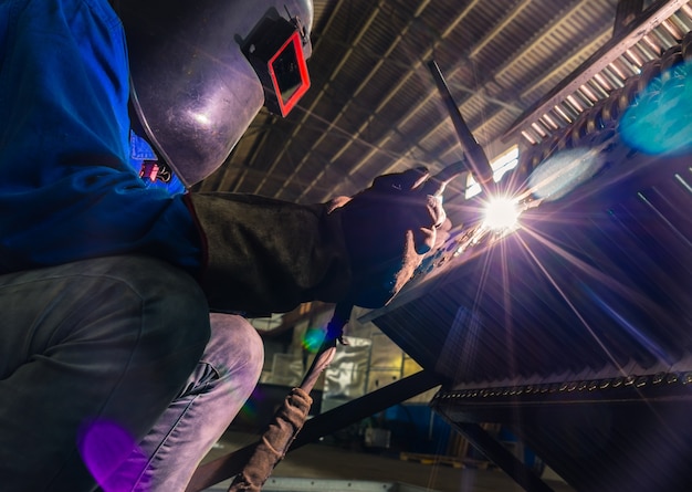 sparks while welder uses torch to welding