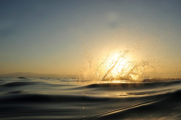 Spashing sea at sunset