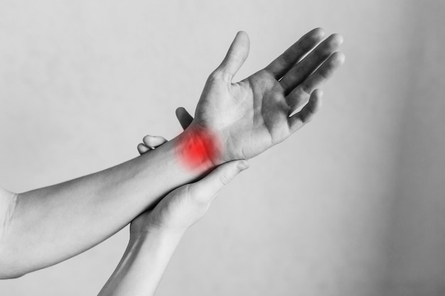 Spasm on the mans wrist Joint and elbow injuries fatigue at work Area of the injury